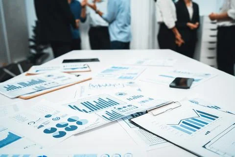 Analyzed financial data visualized papers on meeting table. Prudent Stock Photos