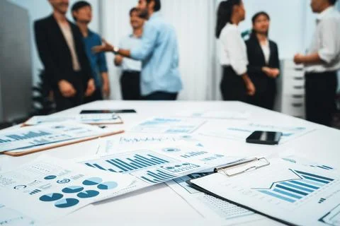 Analyzed financial data visualized papers on meeting table. Prudent Stock Photos