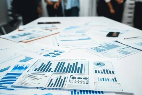 Analyzed financial data visualized papers on meeting table. Prudent Foto stock