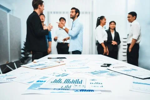 Analyzed financial data visualized papers on meeting table. Prudent Stock Photos