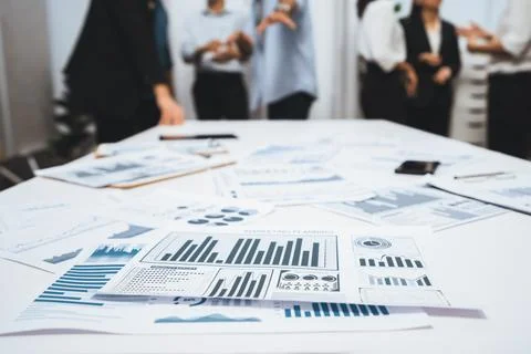 Analyzed financial data visualized papers on meeting table. Prudent Fotos de archivo