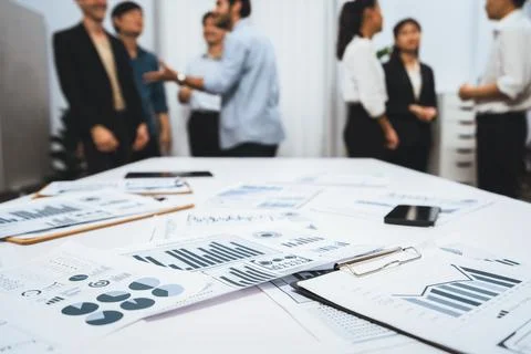 Analyzed financial data visualized papers on meeting table. Prudent Foto stock