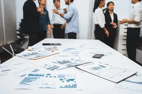 Analyzed financial data visualized papers on meeting table. Prudent Stock Photos