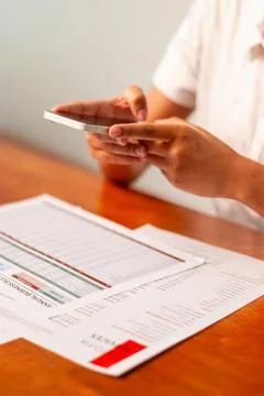Analyzing business reports with mobile devices office digital content indoo.. Stock Photos
