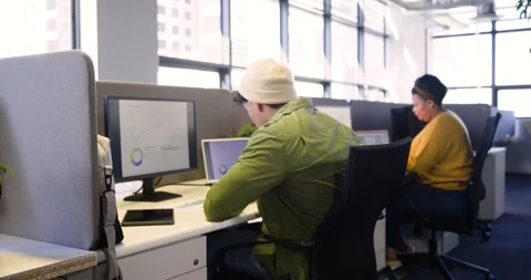 Analyzing charts at desk, man stacking papers tracing pie chart on monitor while Stock Footage 341931761