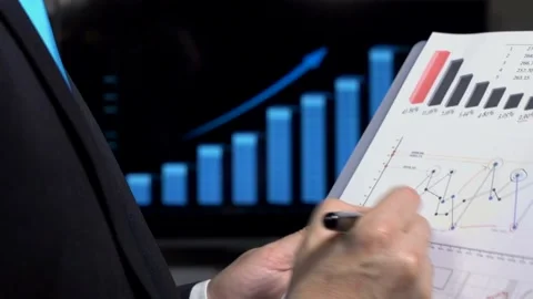 Analyzing charts in office  動画素材 210196185