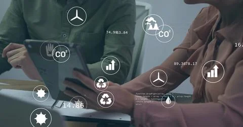 Analyzing CO? data on tablet, businessman and businesswoman pointing at screen Stock Photos