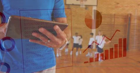 Analyzing coach holding tablet in school gym, with data overlays, children in Stock Photos