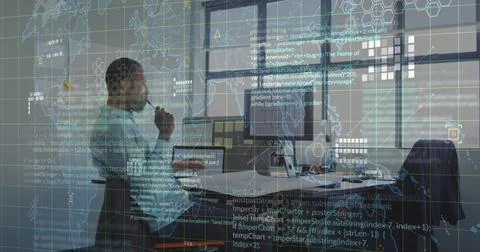 Analyzing code and map overlay on dual monitors in office, African American 写真素材