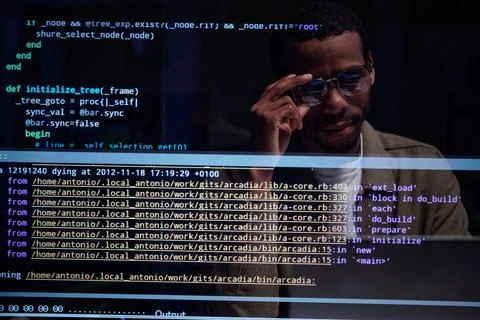 Analyzing Code on Computer Screen with Glasses Stock-Fotos