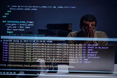 Analyzing Code with Concentration on Computer Screen Stock Photos