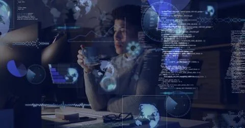 Analyzing code man wearing sweater sipping coffee at monitor in home office with 写真素材