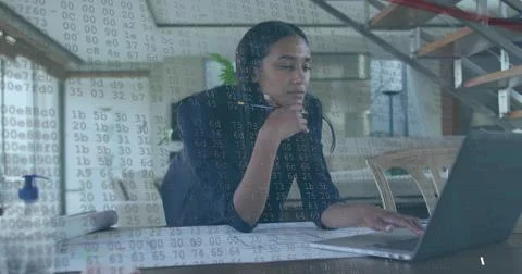 Analyzing code overlay, software engineer wearing blazer at home office with Foto stock