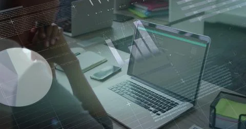 Analyzing colleague studying code overlays on laptop at desk, with smartphone 스톡 사진