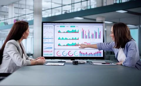 Analyzing Corporate Data on Multiple Screens Stock Photos