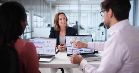 Analyzing data on analytics dashboard during multicultural team meeting Stock Photos