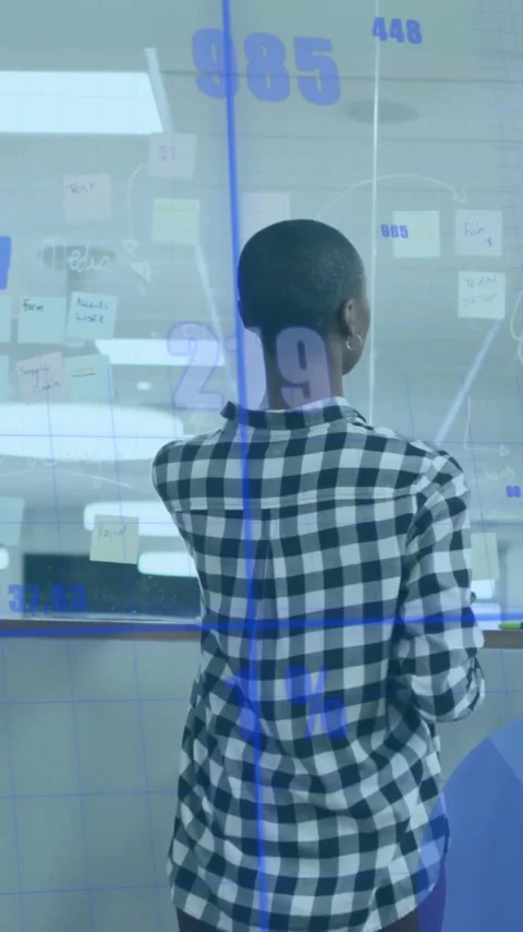 Analyzing data charts, diverse team collaborating in modern office with Stock Footage 319617117