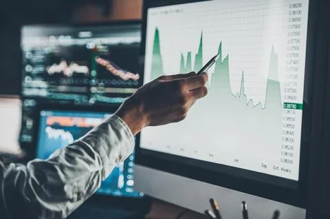 Analyzing data. Close-up of young businessman pointing on the data presente.. 库存照片