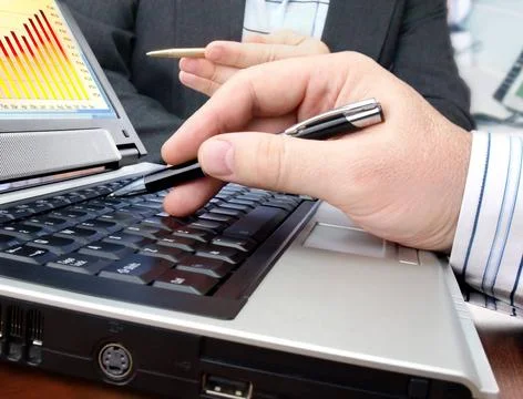 Analyzing data on computer Analyzing data and charts on computer screen Co... Foto stock