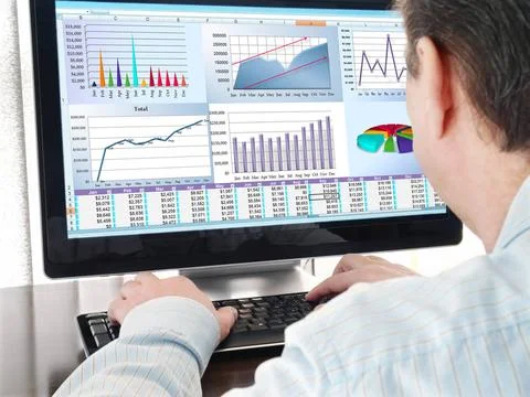 Analyzing Data on Computer Analyzing financial data and charts on computer... Stock Photos