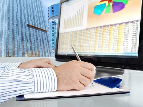 Analyzing Data on Computer Male Hand with Pen in Front of Computer Screen ... Foto stock