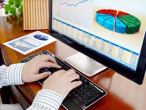 Analyzing data on computer Male hands on the keyboard in front of computer... Stock Photos
