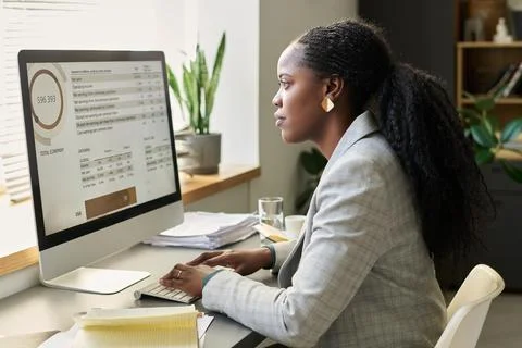 Analyzing data on computer screen 스톡 사진