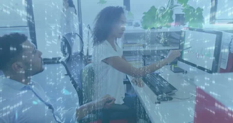 Analyzing data on computer screens, business professionals in office with Stock Footage 303947568