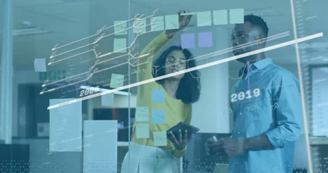 Analyzing data with digital graphs and sticky notes, business professionals in Video stock 303942234