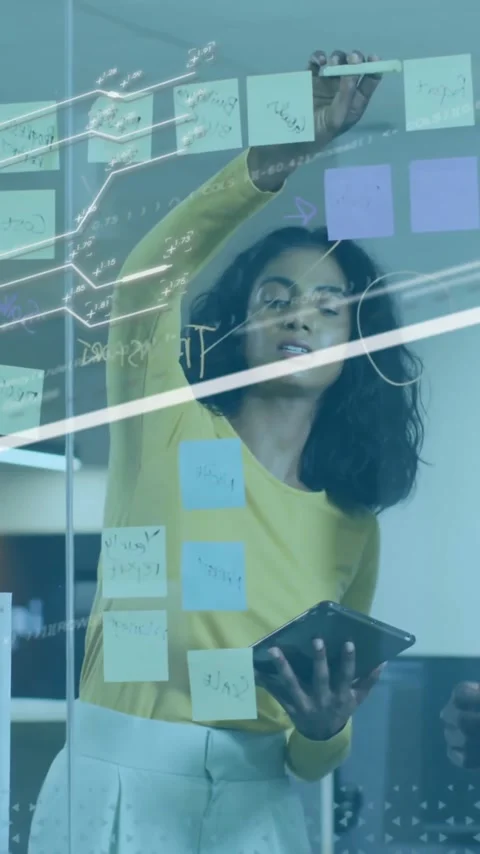 Analyzing data with digital graphs and sticky notes, business professionals in Stock Footage 344244756