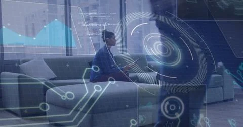 Analyzing data overlays, pair sitting on sectional sofa in office lounge near Stock Illustration