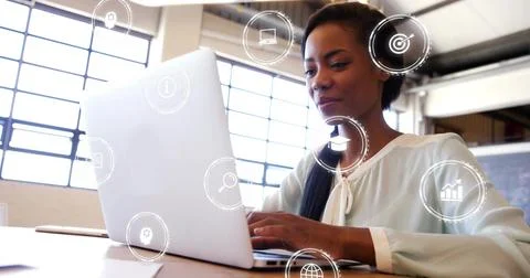 Analyzing data professional woman typing on laptop at open office, floating tech Stock Photos