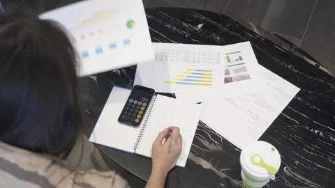 Analyzing Data Reports and Charts in a Modern Workspace Stock Footage 314512020