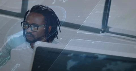 Analyzing data streams, mid adult man with glasses and collared shirt at work Stock Photos
