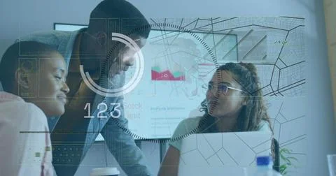 Analyzing data three coworkers leaning over office table, using laptop and Stock Photos