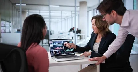 Analyzing Data Together at Multicultural Team Meeting Stock Photos