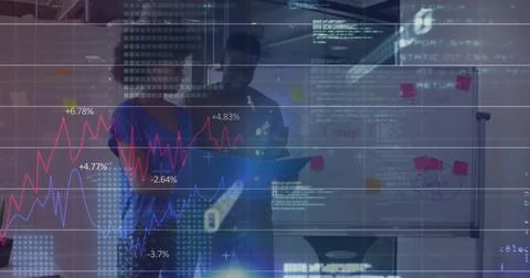 Analyzing diagrams and sticky notes, coworkers wearing business attire in Stock Photos