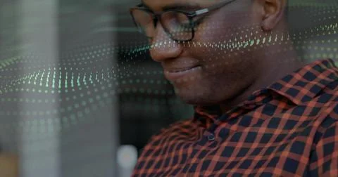 Analyzing digital data overlay at office by man wearing checkered shirt and Stock Photos