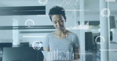 Analyzing documents, businesswoman with data visualization image over office Foto stock