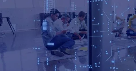 Analyzing documents, group of people sitting on floor with data processing image Stock Photos