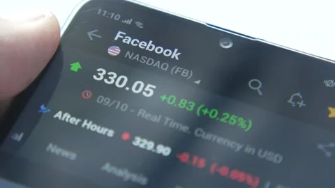 Analyzing facebook stock chart and data on smart phone at night Stock Footage 168141639