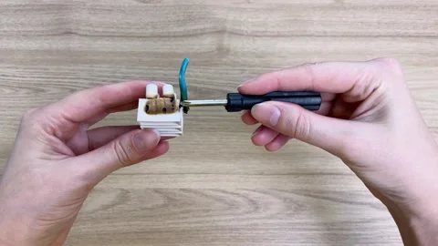 Analyzing a faulty electrical connection using a screwdriver Stock Footage 336609339