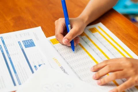 Analyzing financial data sheets home office document review bright environm.. Stock Photos