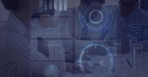 Analyzing group of professionals reviewing printed charts in meeting room, with Foto stock
