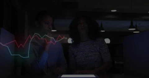 Analyzing market trends two professionals studying tablet in office, holographic Stock Photos