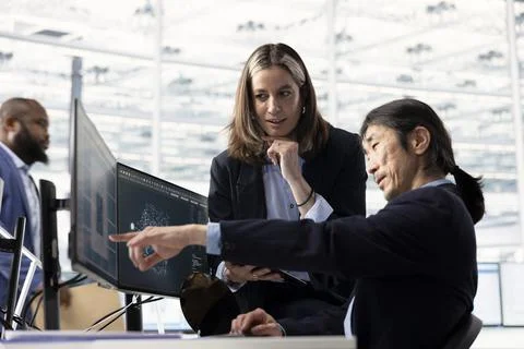 Analyzing microchip architecture layouts, AI and female engineer with coworker Stock Photos