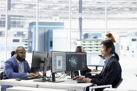 Analyzing microchip architecture layouts, AI and senior technician in RD office Stock Photos