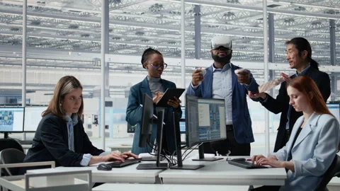 Analyzing PCB architecture, VR headset and multiethnic engineering team Stock Footage 335880291
