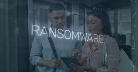 Analyzing professionals viewing digital tablet in office space, with ransomware Stock Photos