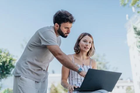 Analyzing statistics, discussing strategy, confident business partners, downtown Stock Photos